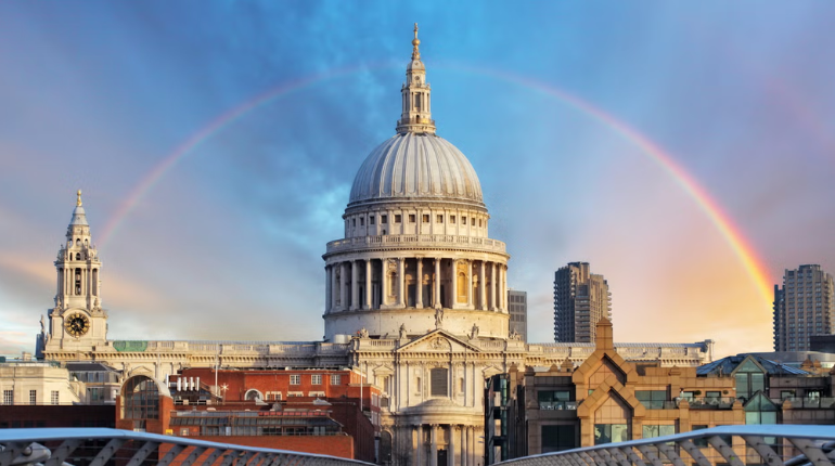 St. Paul’s Cathedral with its grand dome and intricate architecture, framed by a clear blue sky.