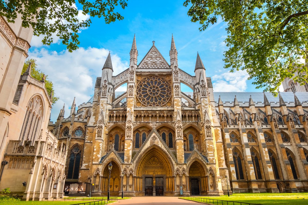 Exterior view of Westminster Abbey showcasing its Gothic architecture with intricate stone carvings.