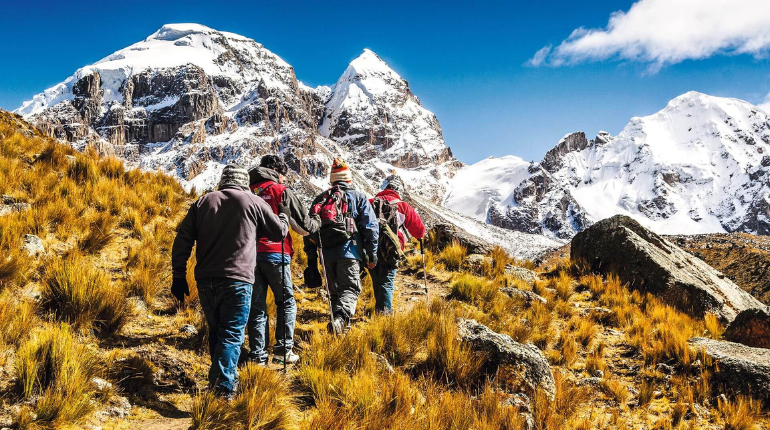 A breathtaking view of the Andes Mountains with a winding trail, representing the beauty of hiking in Peru.